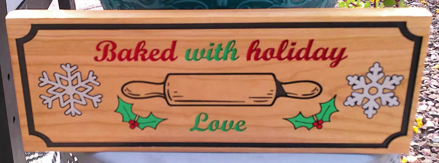 Wooden sign with holiday-themed design and text 'Baked with holiday love' on a blurred outdoor background.