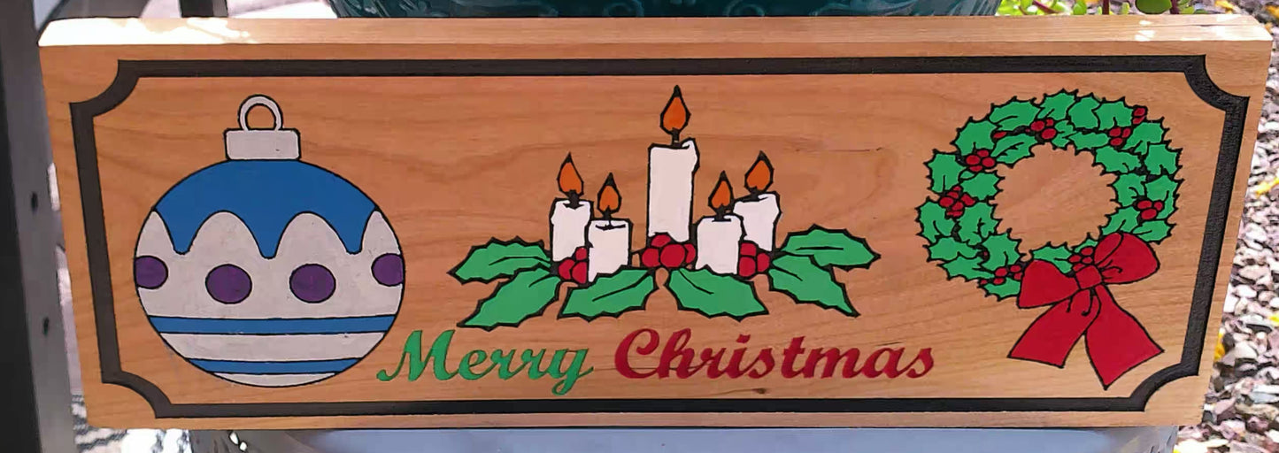 Wooden Christmas sign with ornaments, candles, and wreath on a wooden background