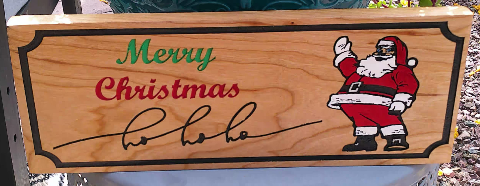 Wooden sign with Santa Claus and 'Merry Christmas' text