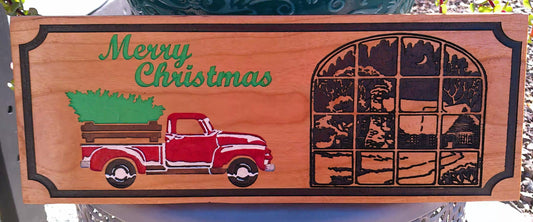 Wooden Christmas sign with a red truck carrying a tree and 'Merry Christmas' text.
