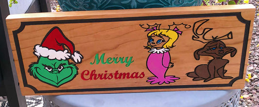 Wooden sign with cartoon characters and 'Merry Christmas' text