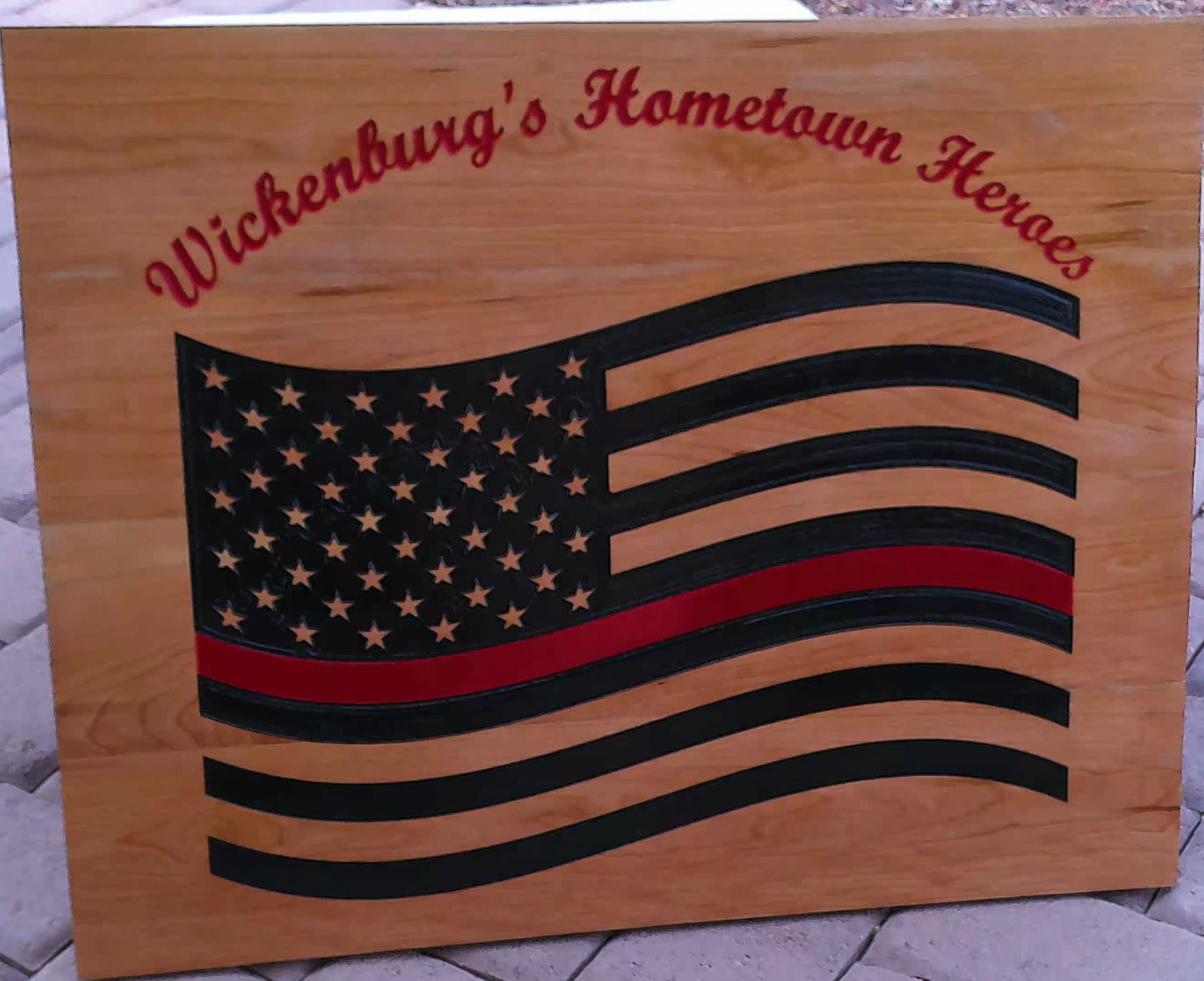 Wooden plaque with American flag design and 'Wickenburg's Hometown Heroes' text.