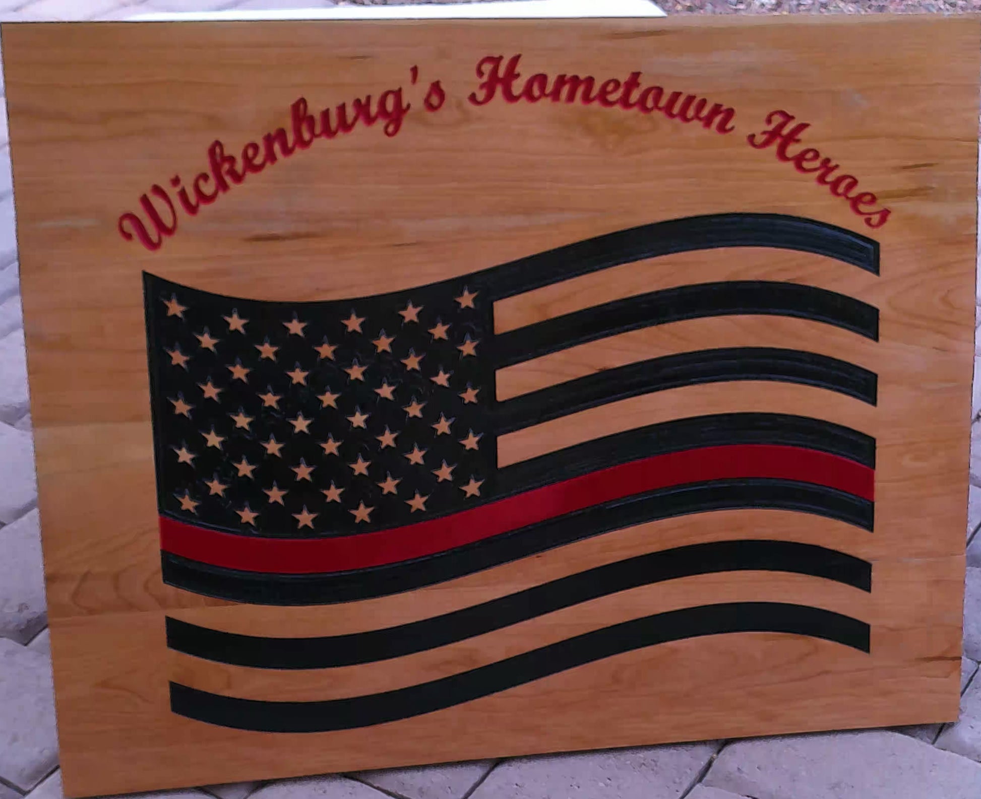 Wooden plaque with American flag design and 'Wickenburg's Hometown Heroes' text.