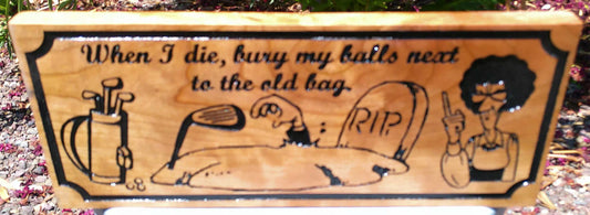 Wooden bench with humorous engraving and illustrations on a natural wood background.
