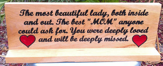 Wooden plaque with engraved text and hearts on a natural background